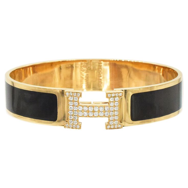 Hermes Clic Clac H Diamond Bangle Bracelet In 18k Yellow Gold And Black Enamel. The bracelet features solid 18kbangle inlaid with black enamel. The "H" shaped lock encrusted with 52 round brilliant cut diamonds with total weight of approximately 0.80 carats, color F-G, clarity VS. Wrist size: 6.25" - 6.5". Width: 12.5mm. Weight: 37.9 grams. Accompanied by original box and outer box. ( retail price is over $40,000) Hermes Clic Clac Bracelet, Snake Bangle, Classic Bangles, Diamond Bangle Bracelet, Modernist Jewelry, Vintage Bangles, Enamel Bangle, Diamond Bangles Bracelet, Gold Snake