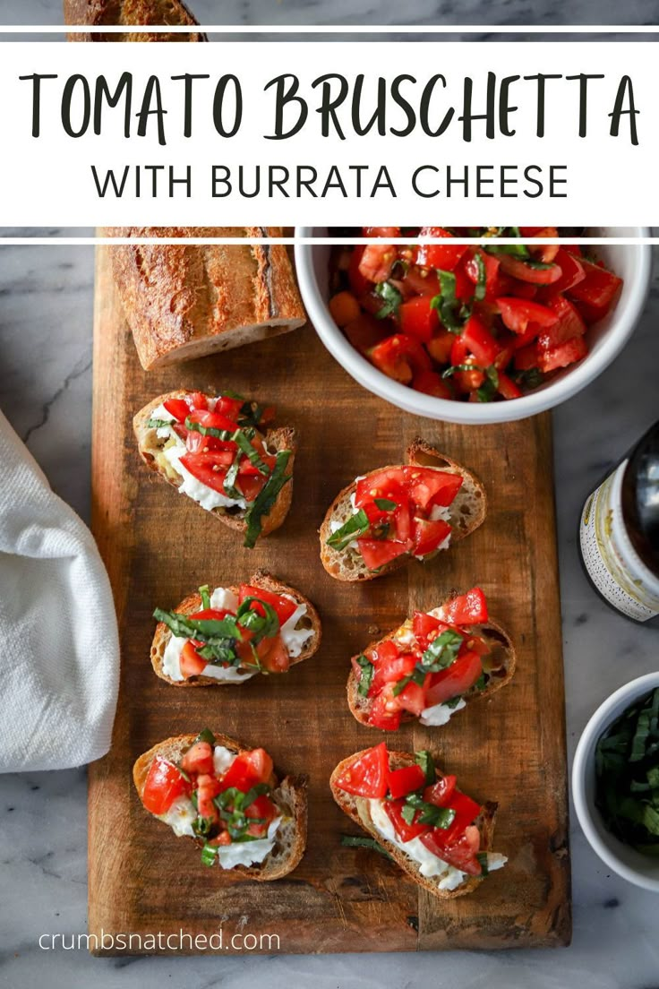 tomato bruschetta with burrata cheese on a cutting board next to other food