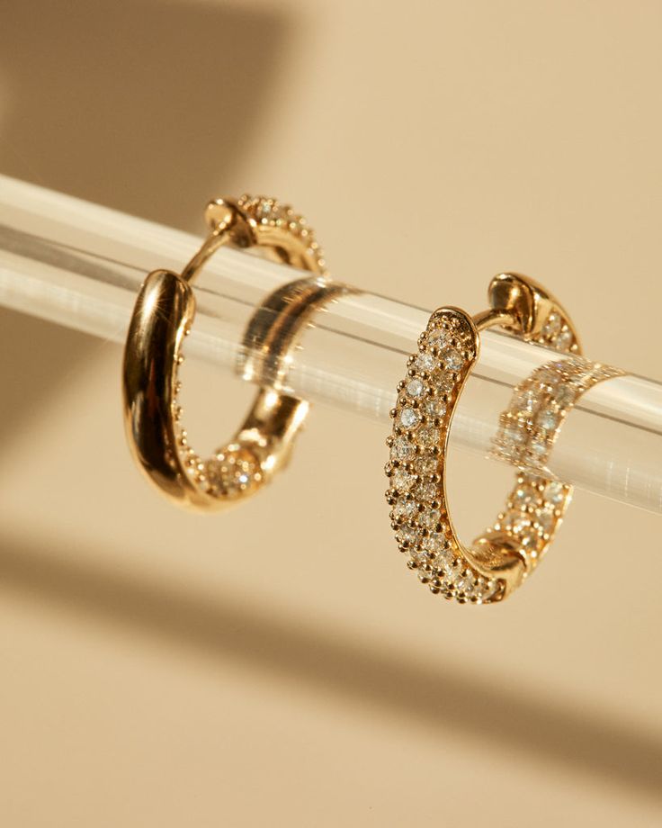 Our Real Diamond Amalfi Huggies are pave version of our Real Deal Amalfi Huggies- featuring glistening white diamonds on both the outer and inner curves of each hoop. The diamonds sparkle in every angle, elevating any outfit and perfect for all day wear. Gold Dazzling Hoop Earrings With Pave Setting, Dazzling Gold Hoop Earrings With Pave Setting, Dazzling Gold Hoop Earrings With Brilliant Cut, Sparkling Stones Huggie Wedding Jewelry, Sparkling Stones Huggie Jewelry For Wedding, Huggie Jewelry With Sparkling Stones For Wedding, Luxury Sparkling Diamond Hoop Earrings, Huggie Earrings With Sparkling Stones For Wedding, Luxury Round Cut Sparkling Diamond Earrings