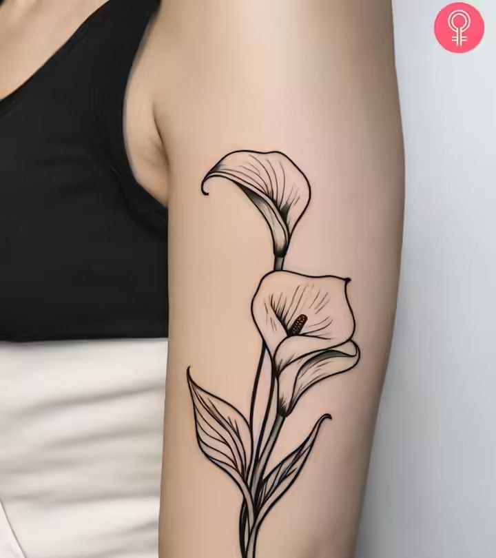 a black and white photo of a woman's arm with a flower tattoo on it