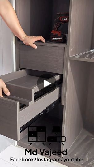 someone is opening the drawers in their kitchen cabinet to check out what's inside