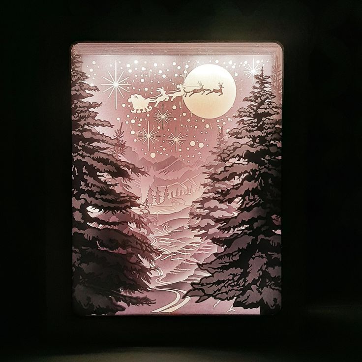 a lit up box with a christmas scene on it