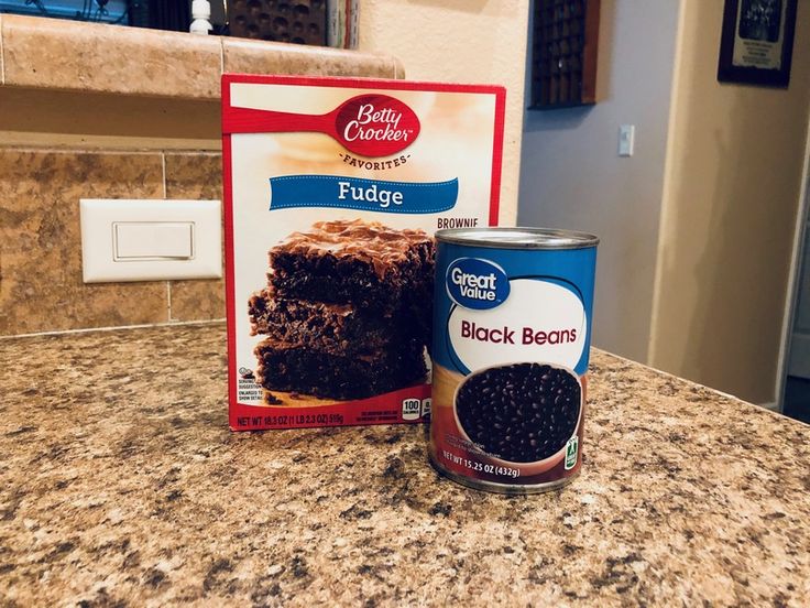 a can of black bean cake next to a package of fudge frosted brownies