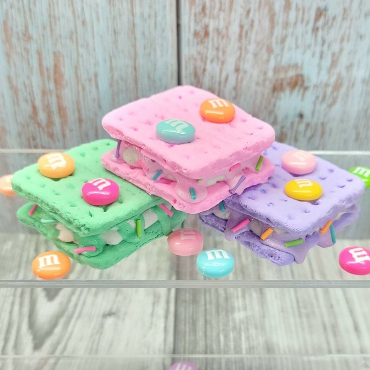 there are three cakes made to look like they have candies on them