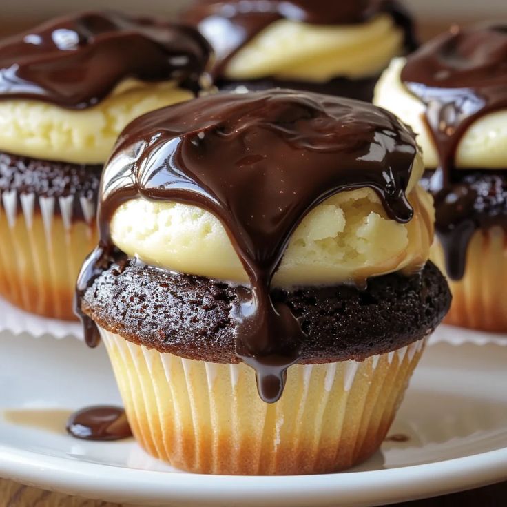 chocolate cupcakes with ice cream and chocolate drizzled on the top