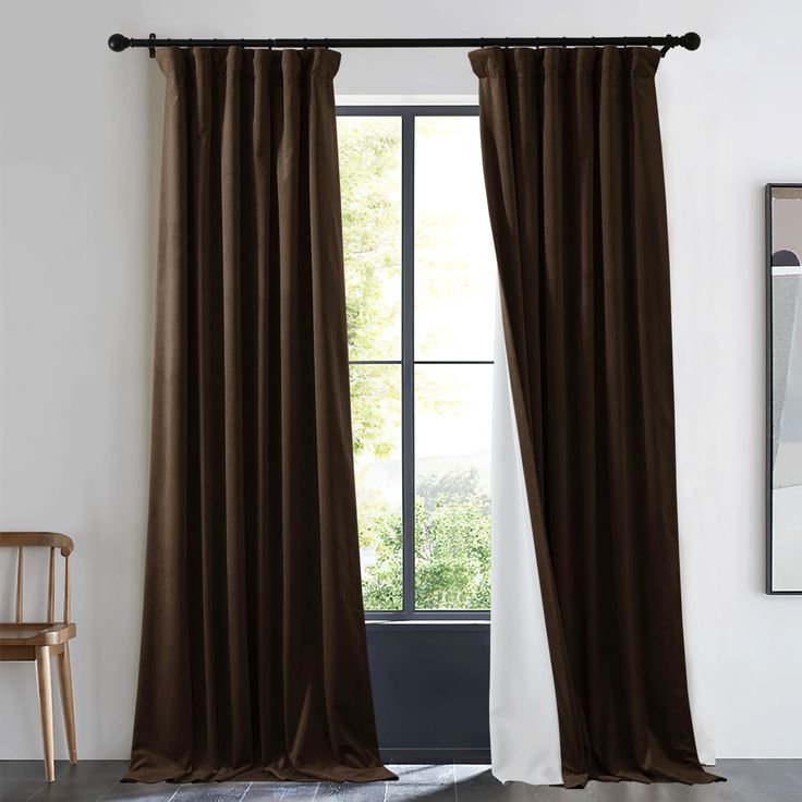 a brown curtain hanging on the side of a wall next to a chair and window