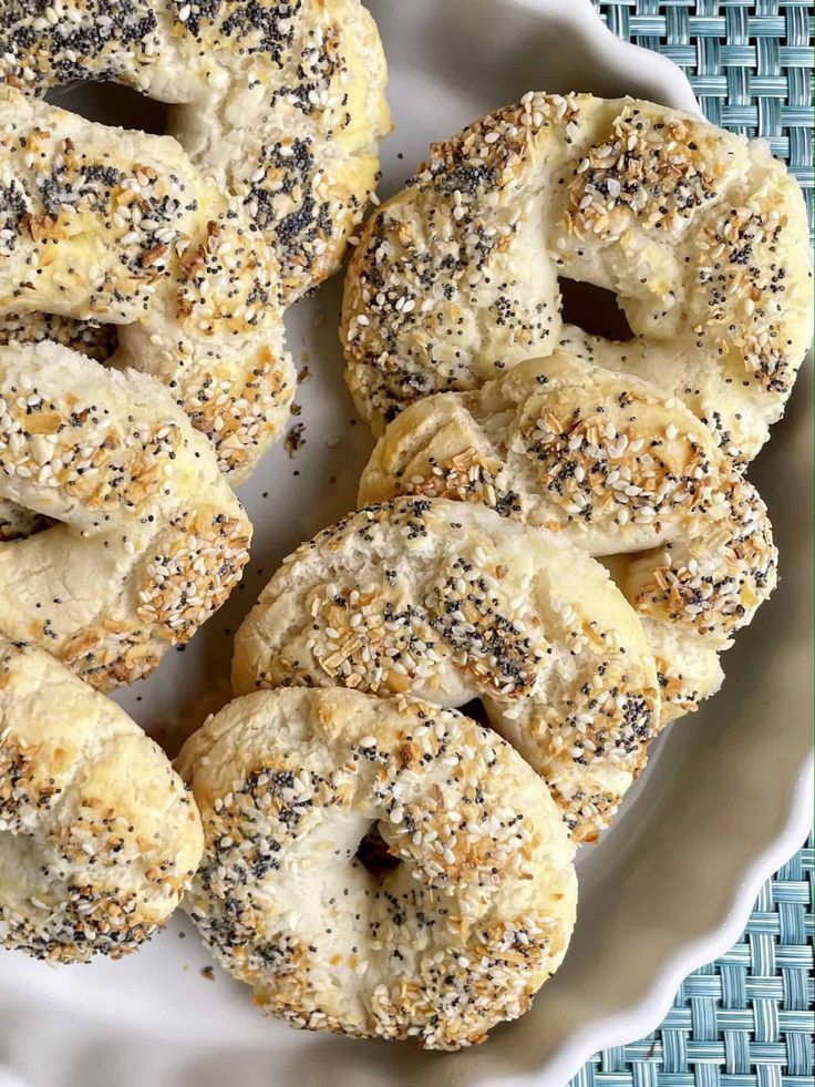 bagels with poppy seed sprinkles on a white plate