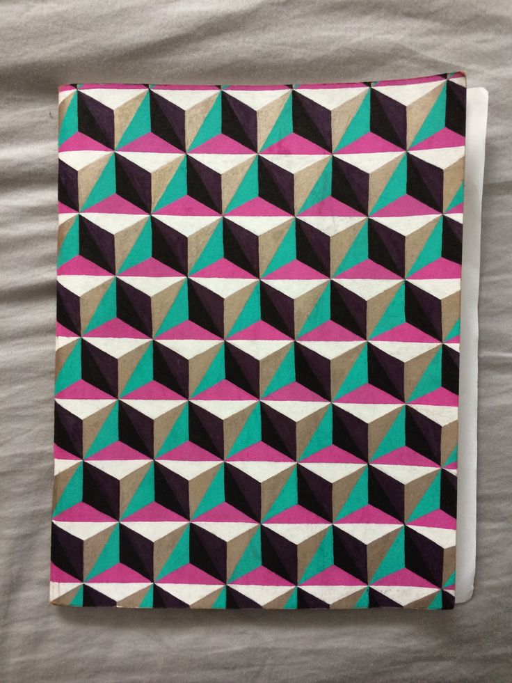 a blanket that is laying on top of a bed next to a pillow with an abstract design