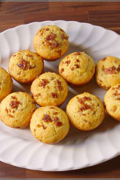 a white plate topped with muffins on top of a wooden table