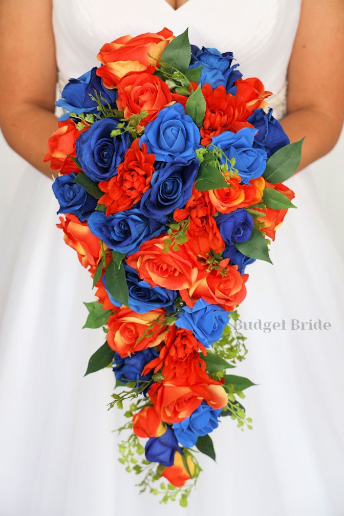 a bride holding a bouquet of red, blue and orange flowers