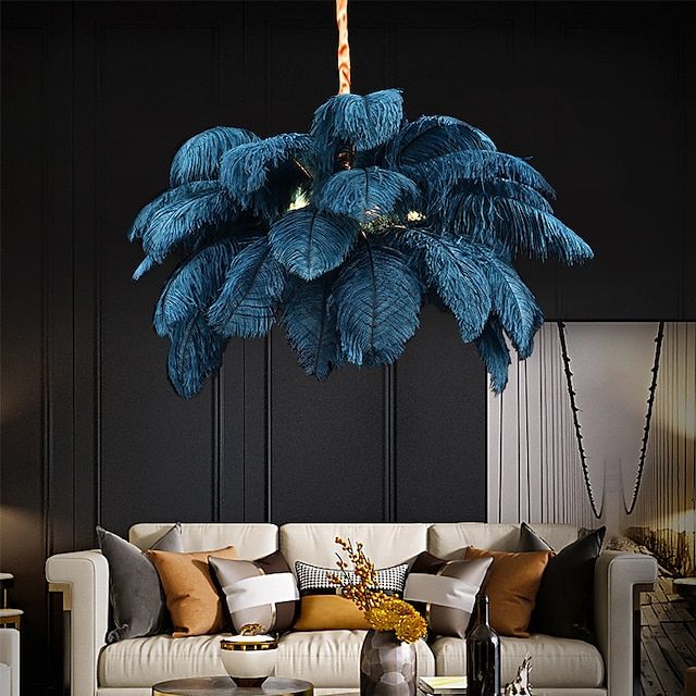 a living room filled with furniture and a large blue plant hanging from the ceiling above it