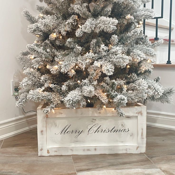 a white christmas tree in a wooden box