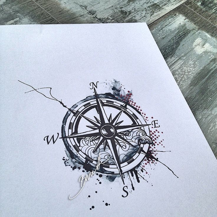 a drawing of a compass on paper with ink splatters and watercolors