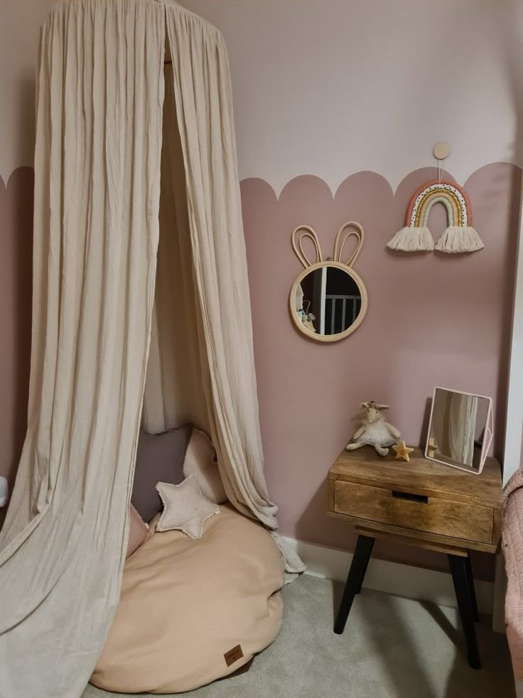 a bedroom with pink walls and white curtains