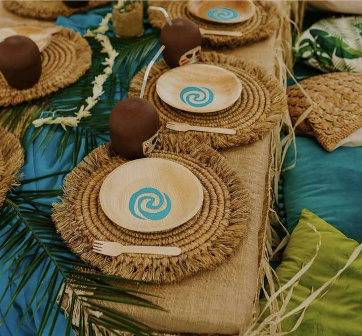 the table is set with plates and place settings for guests to sit down on it