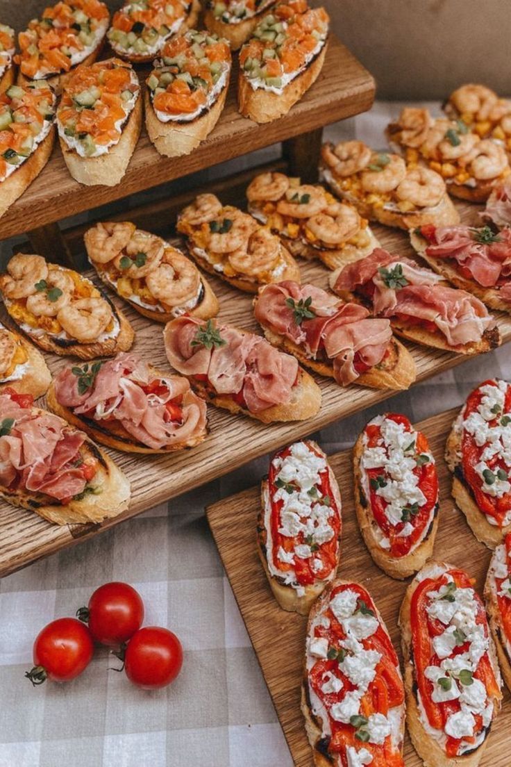 several wooden trays filled with different types of appetizers and food on display