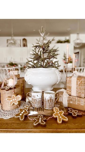 gingerbreads and cookies are arranged on a table in front of a christmas tree