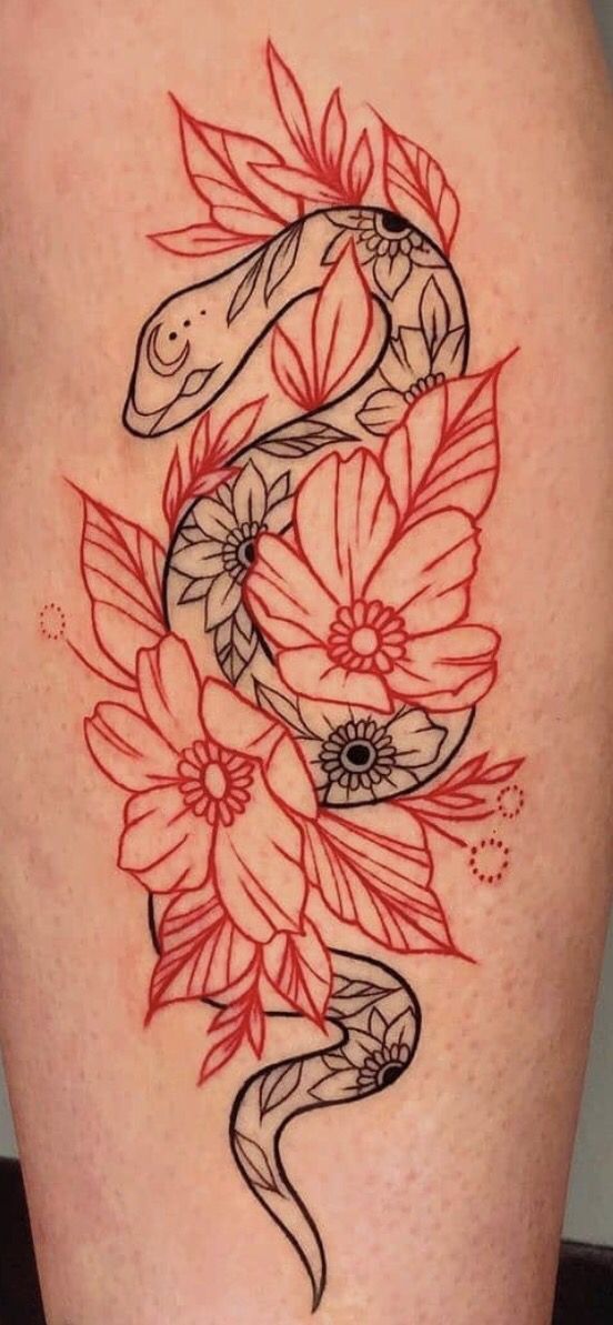 a snake and flowers tattoo on the back of a woman's thigh with red ink