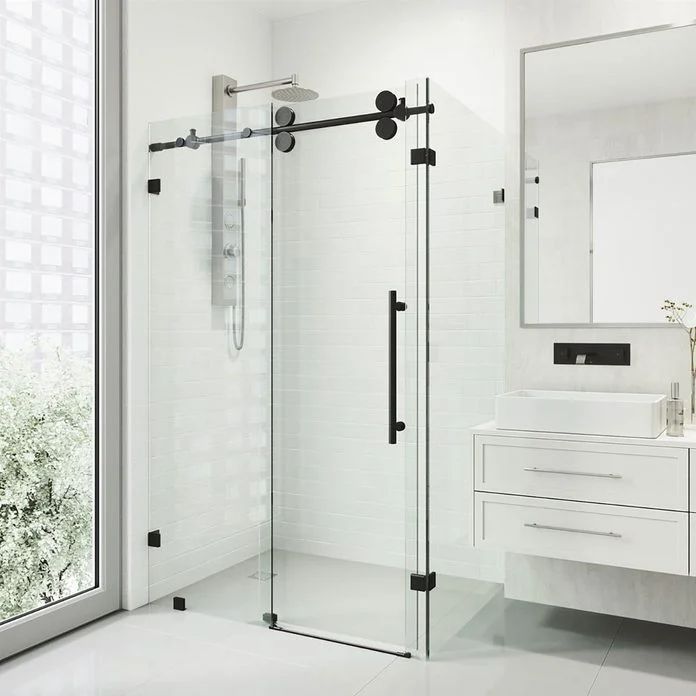 a bathroom with a walk in shower next to a white sink and mirror on the wall