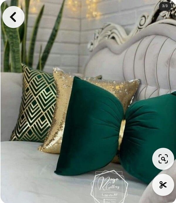 the pillows are green and gold on the bed