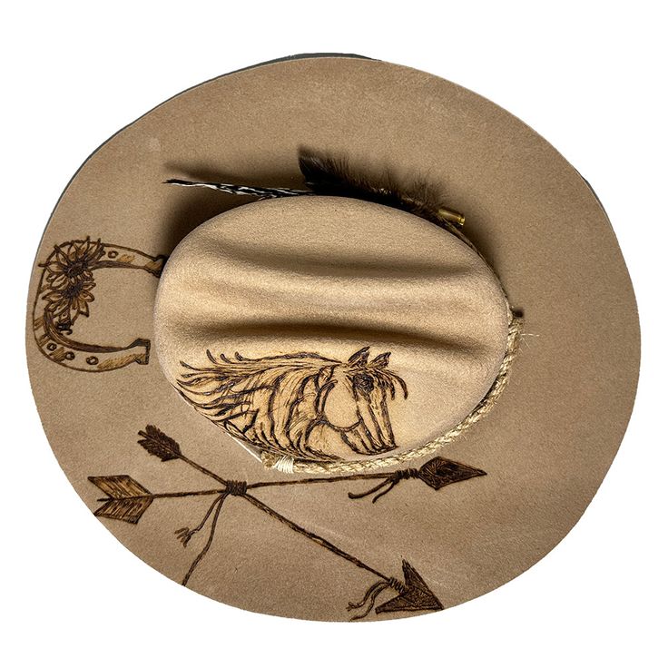 Cowboy hat custom burned by hand specifically for Bourbon Cowgirlby KC Lids. These hats are exclusive and only found here. We worked with the designer to create our very own look. 100% wool hat. One size fits all, as the interior band is adjustable to fit most. A beautiful cattleman rancher style, this distressed almond / beige colored hat is sanded and torched to a beautifully burnished and distressed finish. Firm shape (do not crush). Our artisan has hand burned a beautiful horse with flowing Custom Felt Hat For Country Events, Artisan Ranch Hat With Short Brim, Artisan Hat With Short Brim For Ranch, Artisan Short Brim Hat For Ranch, Felt Cap Hat For Country Events, One Size, Felt Cap Hat For Country Events, Felt Cap For Country Events, Custom Felt Hat For Rodeo, One Size, Handmade Brimmed Hat For Ranch