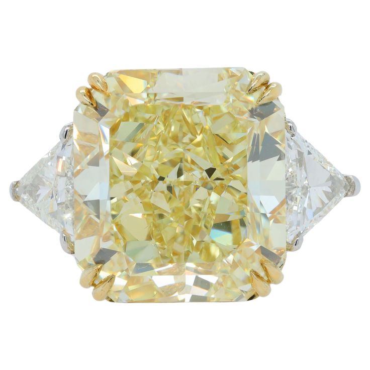 Platinum and 18 kt yellow gold engagement ring featuring a center (FIY VS2) 23.88 ct Radiant cut yellow diamond(GIA# 5161984914) with 1.56 cts tw of trilliant diamonds on the sides Canary Diamond Ring, Yellow Diamond Ring, Canary Diamond, Yellow Diamonds Engagement, Yellow Diamond Rings, Fancy Yellow Diamond, Trendy Fashion Jewelry, Jewelry Appraisal, Jewelry Rings Diamond