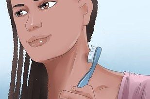 a woman brushing her teeth with an electric toothbrush