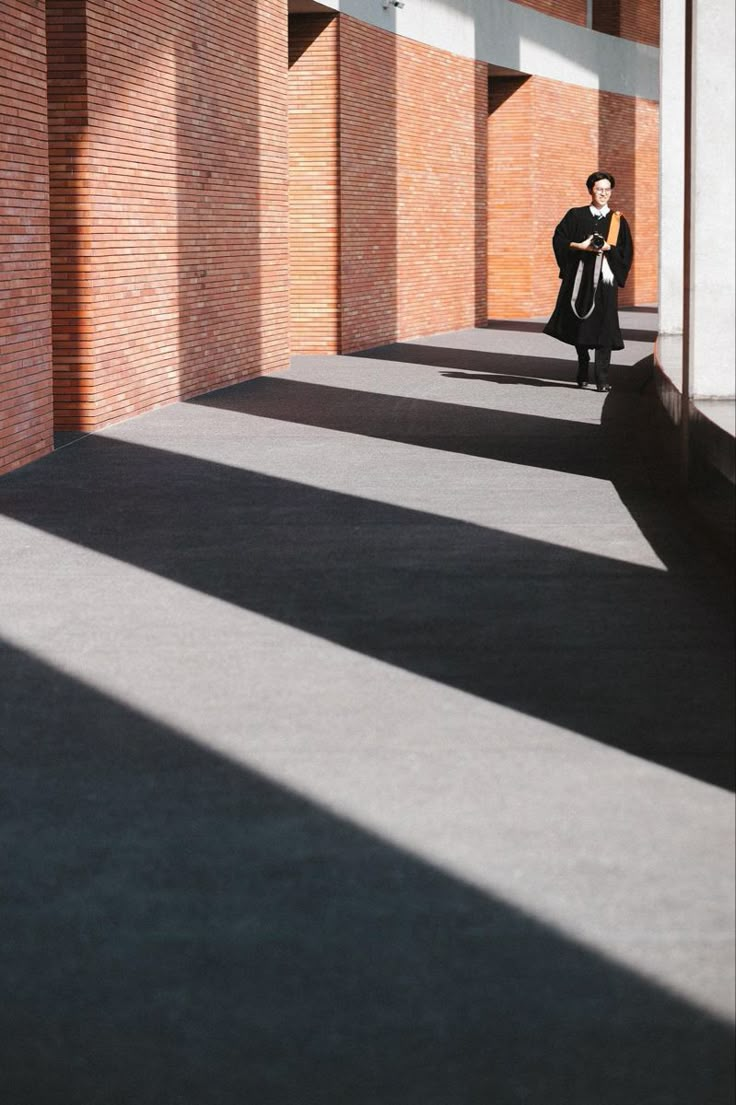 a woman is walking down the street with her cell phone in her hand and she is wearing a black coat