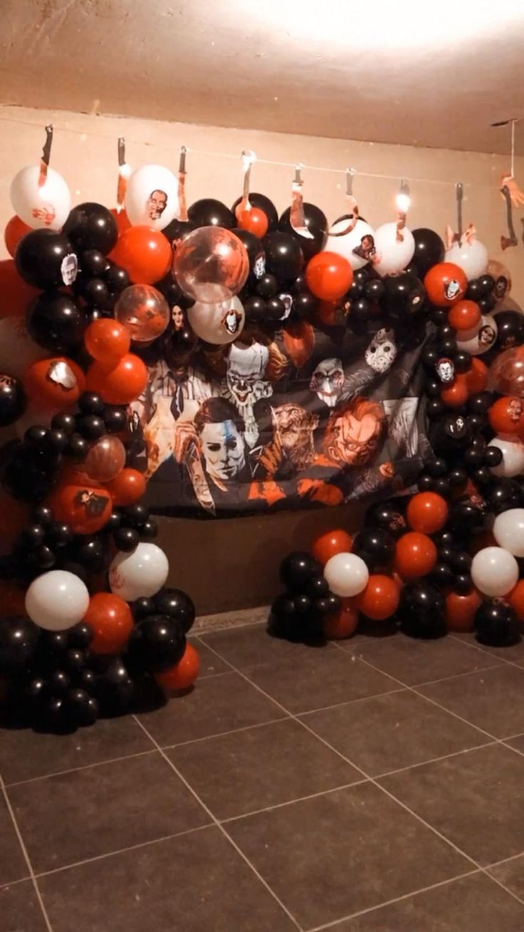 balloons are arranged in the shape of an arch with skulls and faces on it, along with other decorations