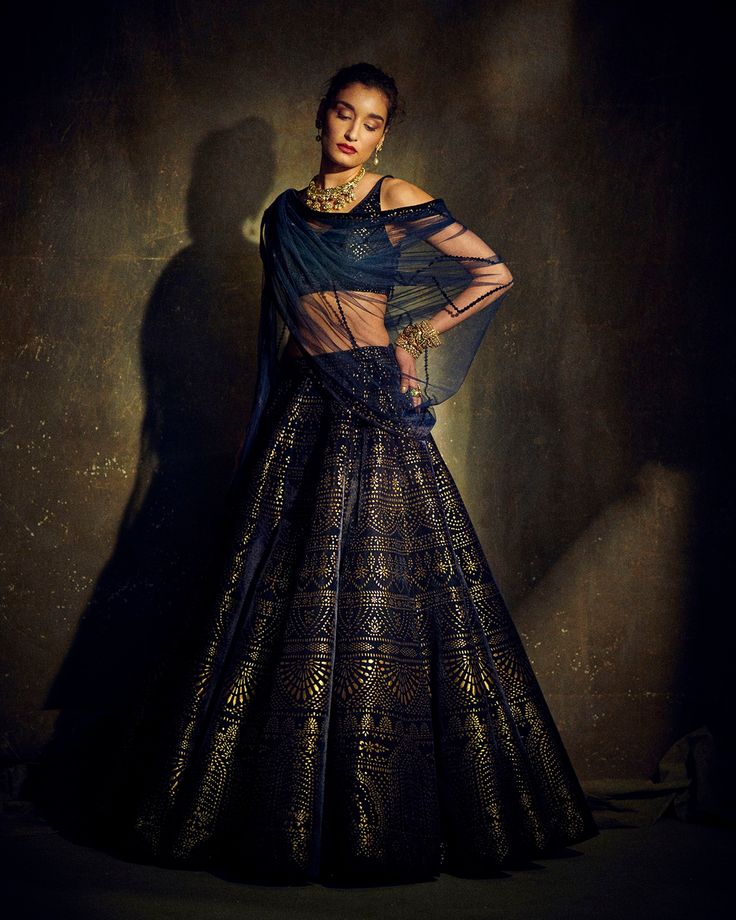 This lush velvet lehenga set features intricate cut work and an antique gold shimmer. The outfit is paired with a net dupatta.From Seema Gujral's Mystique collection. DELIVERY TIMEPlease allow 8-12 weeks for your outfit to arrive. FABRIC DETAILSVelvet, Net. Professional cleaning only. Blue Velvet Lehenga, Dark Blue Lehenga, Royal Blue Lehenga, Navy Blue Lehenga, Seema Gujral, Gold Lehenga, Lehenga Saree Design, Velvet Lehenga, Reception Outfit