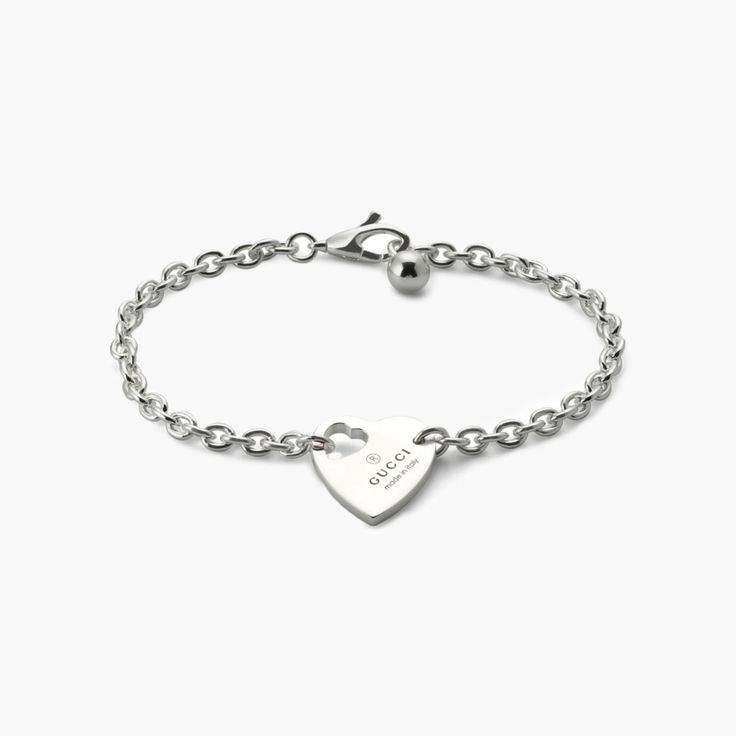 From the cut-out heart to the padlock charm, playful symbols continue to distinguish the jewelry for Pre-Fall 2024. This Gucci bracelet, crafted in sterling silver, features Gucci's trademark engraving on a heart pendant. Adjustable Silver Bracelet With Logo Charm, Gucci Sterling Silver Bracelet, Classic Heart Charm Bracelet In White Gold, Gucci Sterling Silver Jewelry With Polished Finish, Gucci Engraved Jewelry For Anniversary, Sterling Silver Heart Pendant Bracelet In White Gold, Silver Personalized Heart Bracelet, White Gold Classic Heart Charm Bracelet, White Gold Sterling Silver Heart Pendant Bracelet