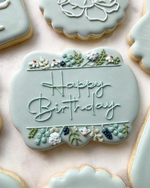 decorated cookies with frosting saying happy birthday