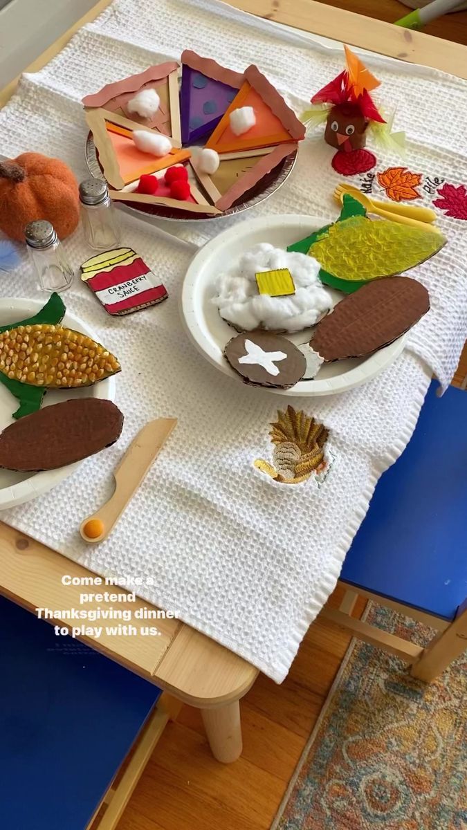 a table topped with plates and bowls filled with different types of food on top of a white table cloth