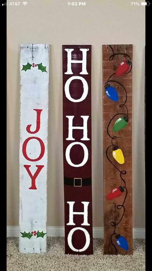 three wooden christmas signs with the word ho hoo painted on one side and holly decorations on the other