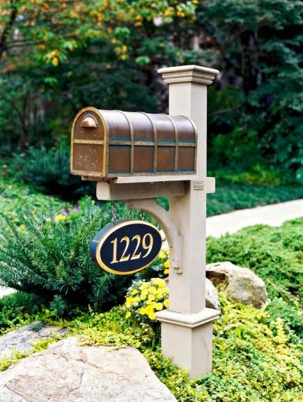 a mailbox in the middle of a garden