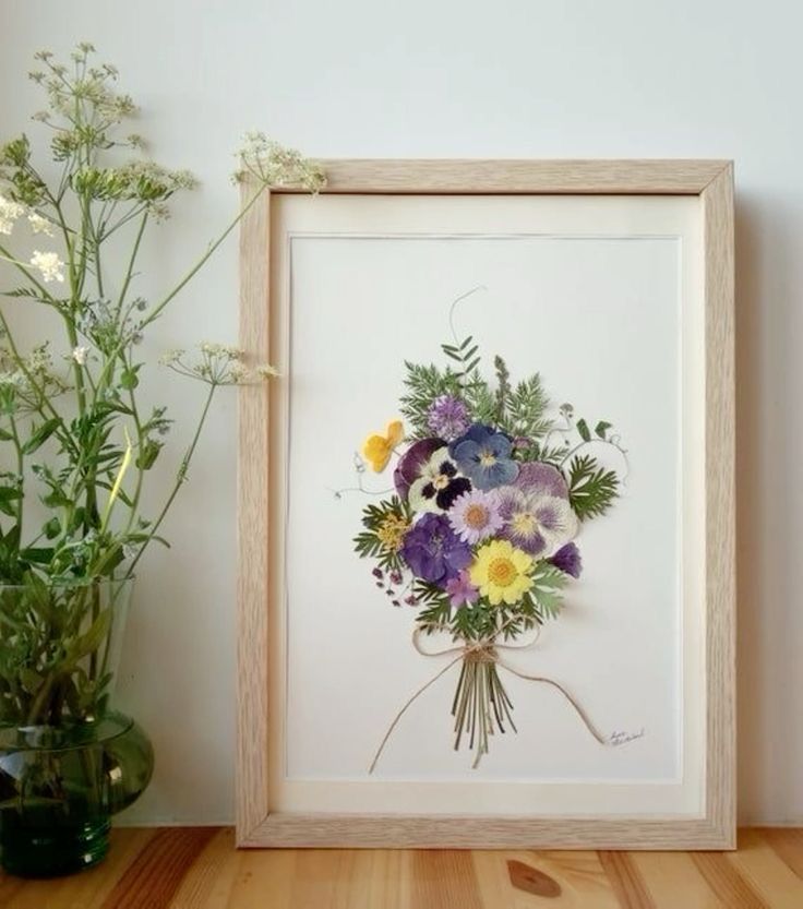 a bouquet of flowers in a wooden frame