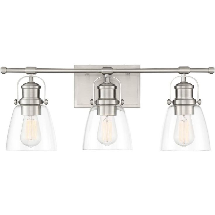 three light bathroom fixture with clear glass shades on the sides and chrome finish, in an old