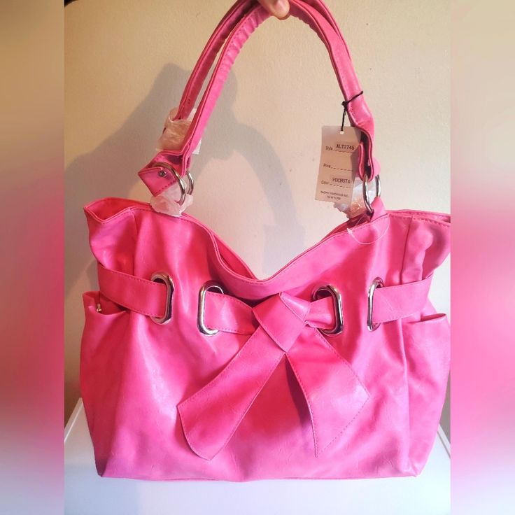 Beautiful Fuchsia Colored Soft Leather Purse!!! Never Worn Before/Brand New Bag With Tags!!! Super Soft Purse And Sturdy Comfortable Handles!!! Color Looks Fuchsia But In Sunlight Can Look Bubblegum Colored Pink!!! This Bag Has Dark Pink Fuchsia Interior With Lots Of Storage Space Plus This Bag Has 2 Side Pockets For Storage On The Exterior Along With A Zipper On The Back Of The Purse For Small Items!!! Beautiful New Yorker Purse For Everyday Wear!!! Easy To Clean!!!! Makes A Awesome Gift Origin Trendy Pink Bag With Silver-tone Hardware, Trendy Pink Shoulder Bag With Silver-tone Hardware, Chic Pink Shoulder Bag With Silver-tone Hardware, Bubblegum Color, Soft Leather Purse, Pink Tote Shoulder Bag With Silver-tone Hardware, Fuchsia Color, Fuchsia Pink, Leather Purse