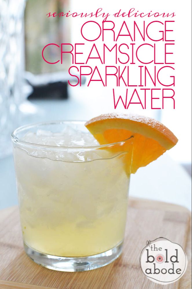 the orange creamsice sparkling water is garnished with an orange slice