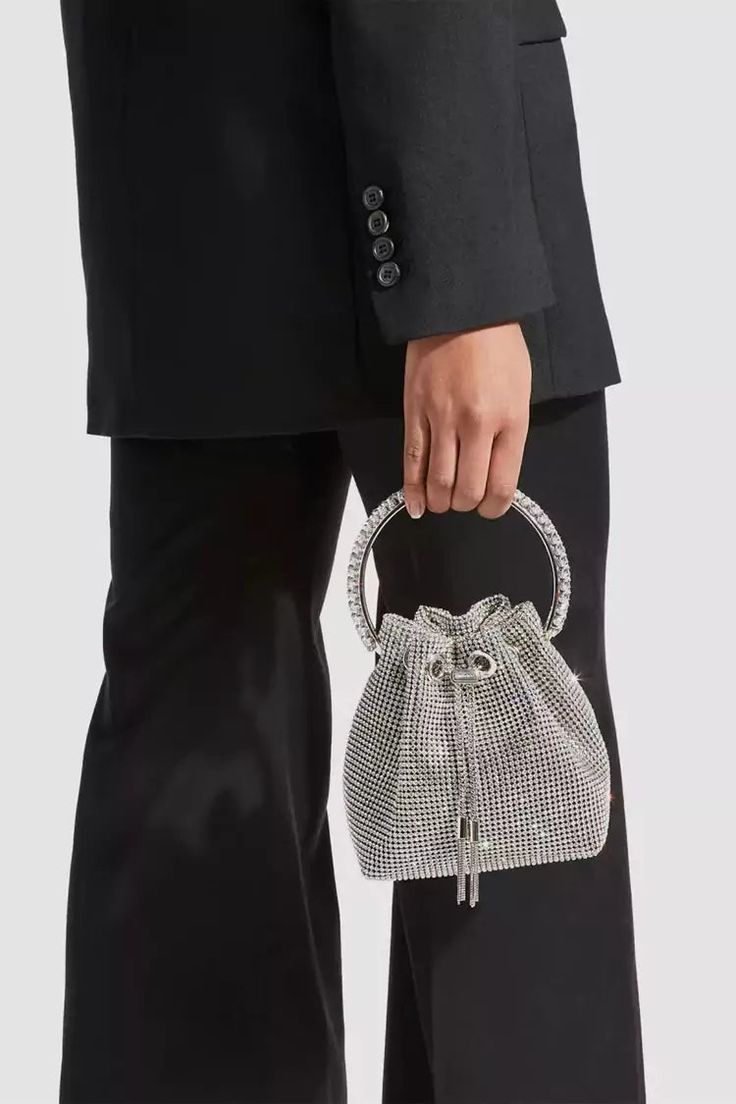 Love the Harlow Silver Crystal Embellished Bucket Bag for all occasions! This bag is made of PU material, and the surface is inlaid with hot diamonds. The chain allows you to straddle your body diagonally. The handle on the top makes it easy to carry it anywhere. This is a great accessory choice whether worn with dress Stretch Mesh Fabric, Embellished Bags, Rhinestone Clutch, Embellished Heels, Drawstring Bucket Bag, Rhinestone Decor, Shoulder Chain, Bon Bon, Elegant Accessories