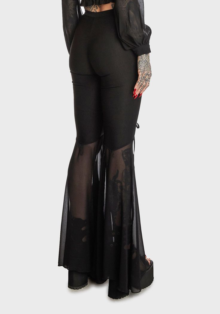 for finding your inner peace. These high-waisted pants have a stretchy double-knit Ponti construction, front cutouts with adjustable lace-up ties, sheer chiffon flared legs, and a side zip closure. Related: Lace-up Pants, Cut-out Bodysuit, Vinyl Bodysuit, Plus Size Pride Clothes, Platform Shoes, Platform Loafers, Rave Boots and Shoes, and Vinyl Clothing. Pants With Cutouts, Gothic Flare Fitted Pants, Gothic Black Flare Bottoms, Sheer Black Full-length Bottoms, High Waist Fitted Sheer Pants, Edgy Flare Bottoms For Party, Edgy Flare Pants For Party, Gothic Fitted Bottoms, Sheer Black Bottoms