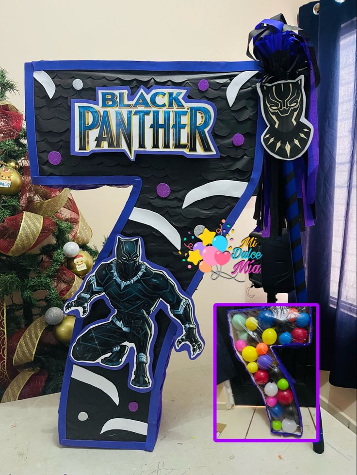 the black panther sign is next to a christmas tree with decorations on it and an ornament