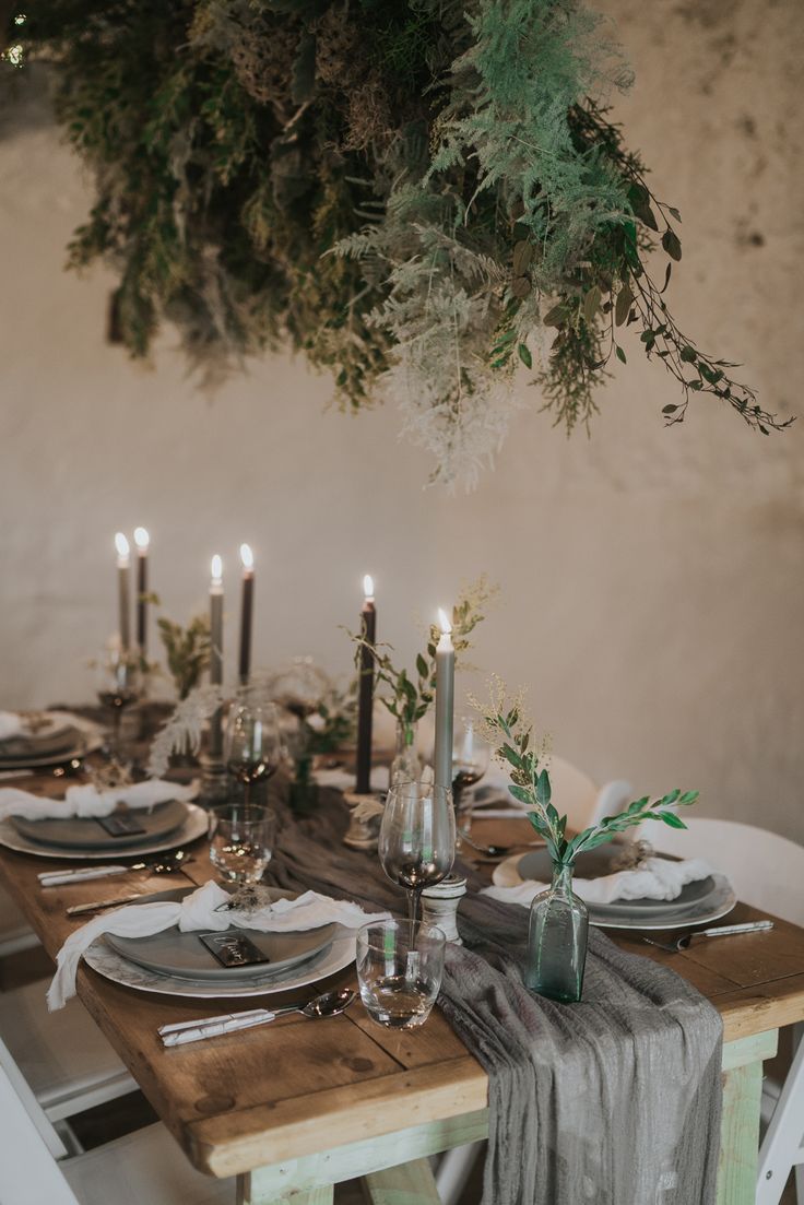 the table is set with candles and plates