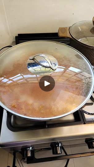 a frying pan sitting on top of a stove next to a pot filled with liquid