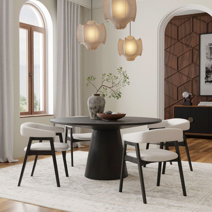 a dining room table with chairs and a vase on it in front of a window