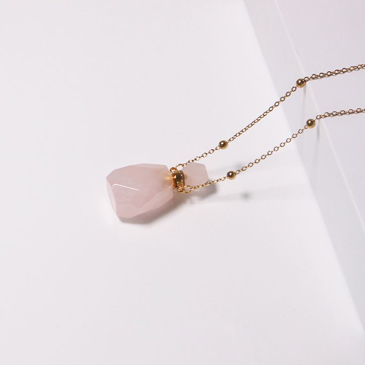 PLEASE NOTE: Our crystal stones are natural minerals and each crystal is unique. The internal ice cracks, pits, mineral points, and color differences of natural crystals are all formed naturally and are normal phenomena, which will not affect the efficacy, beauty and value of the crystal at all.This gorgeous rose quartz crystal bottle necklace will become part of your go-to jewelry! Each bottle is made of natural gemstones and minerals, connected by a stainless steel chain. You may fill the bott Gift Gemstone Beads Crystals, Rose Gemstone Jewelry As A Gift, Rose Gemstone Jewelry For Gift, Rose Gold Crystal Necklaces For Jewelry Making, Rose Gold Crystal Gemstone Necklace For Gift, Mineral Crystal Necklaces As A Gift, Mineral Crystal Necklaces With Stones As Gift, Delicate Crystal Necklaces With Gemstone Beads For Gifts, Rose Gold Gemstone Beads Jewelry For Gift