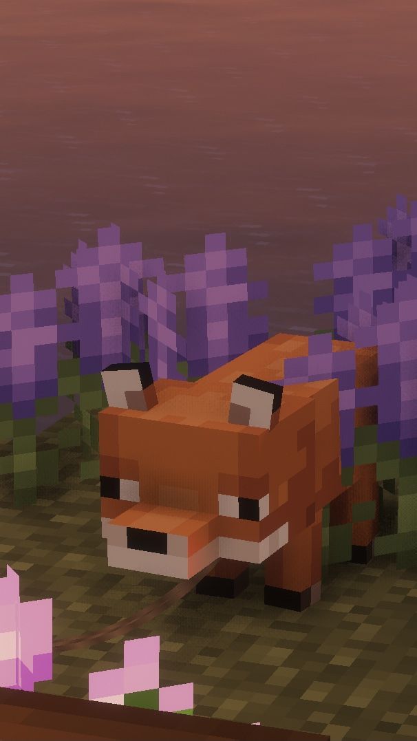 an animal is standing in the middle of some purple flowers and grass with trees behind it