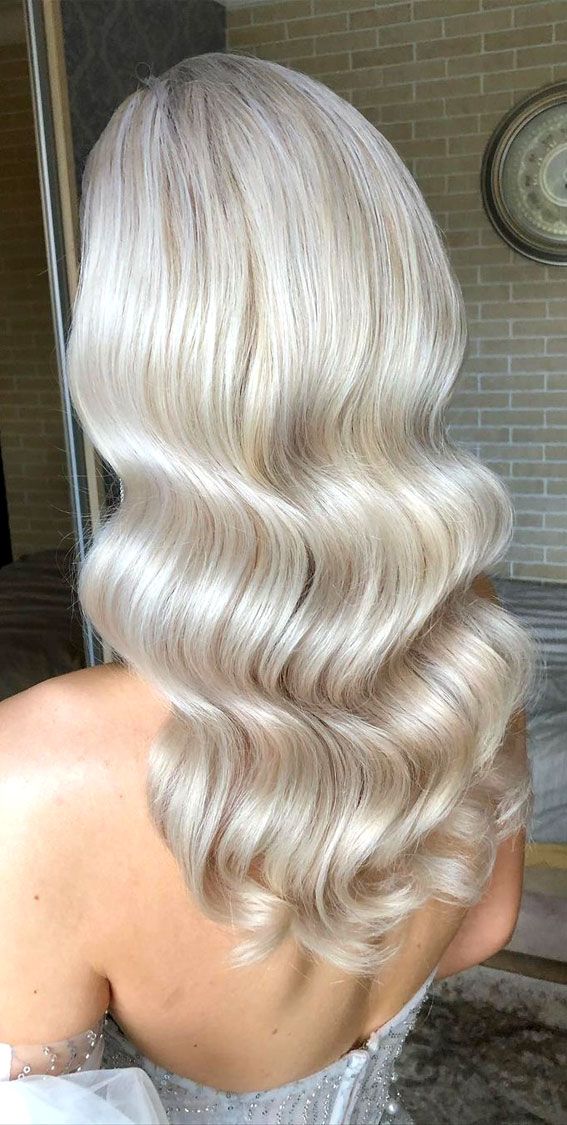 the back of a woman's head with long blonde hair and wavy white hair