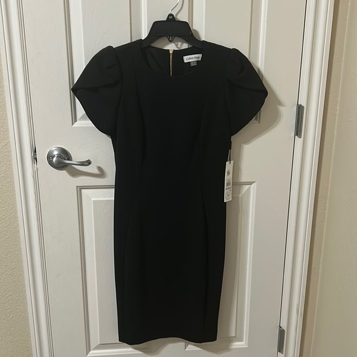 Women’s Calvin Klein Black Dress, Brand New. Size 6 Chic Calvin Klein Short Sleeve Mini Dress, Calvin Klein Knee-length Midi Dress For Night Out, Calvin Klein Fitted Midi Dress For Date Night, Elegant Black Calvin Klein Dress, Fitted Calvin Klein Midi Dress For Date Night, Calvin Klein Black Dress For Work, Calvin Klein Black Formal Dress, Calvin Klein Black Workwear Dress, Calvin Klein Formal Mini Length Dress