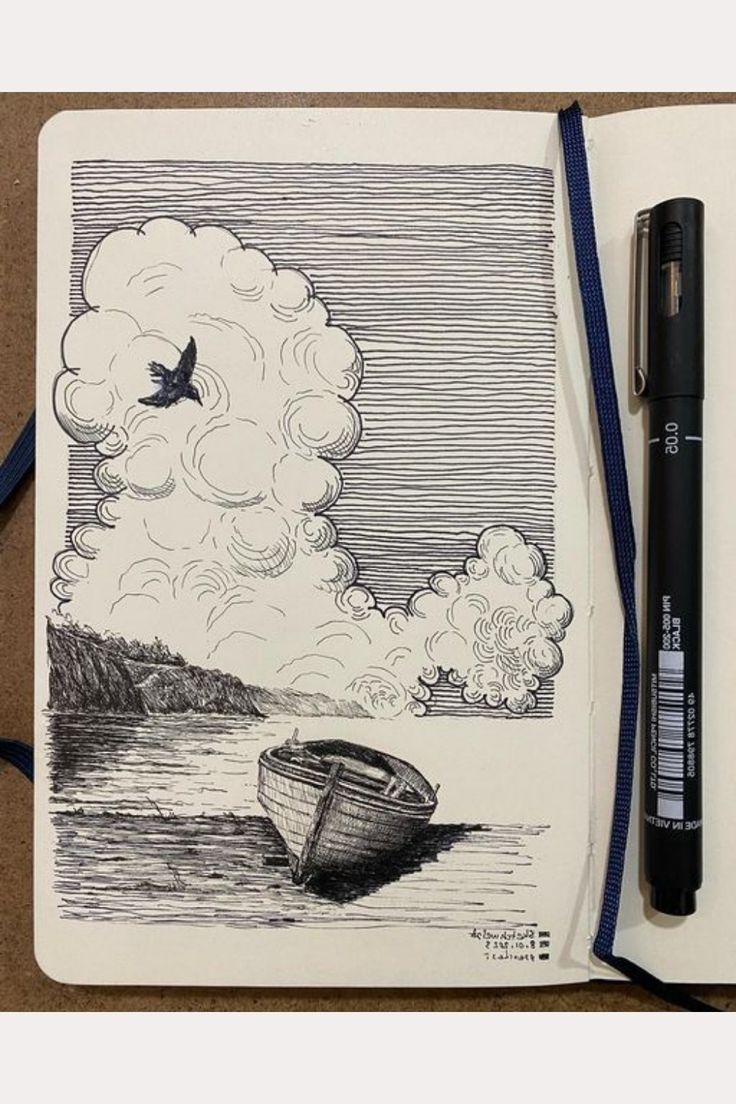 an open notebook with a drawing of a boat in the water and a bird flying over it